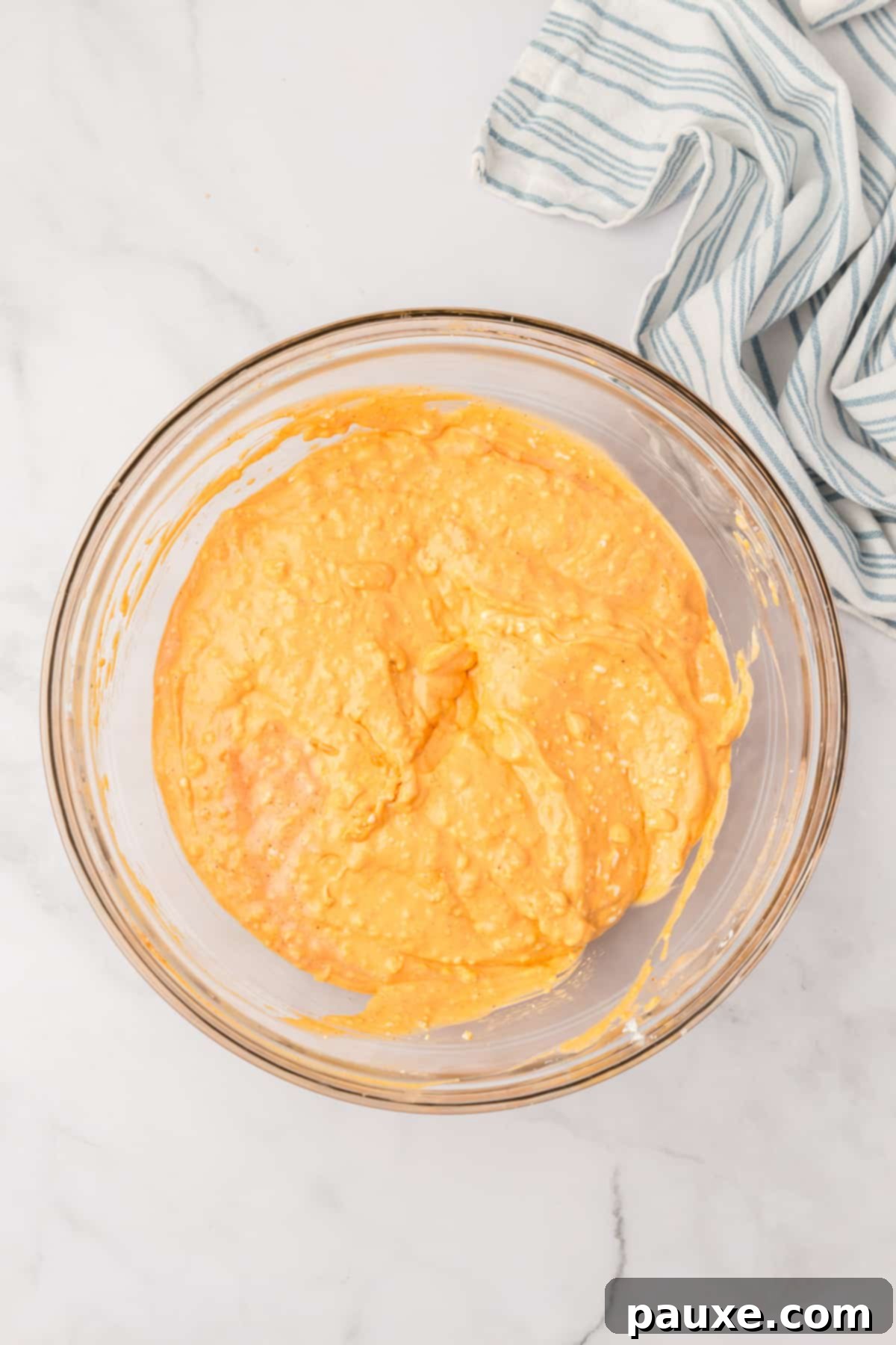 Zesty Slow Cooker Buffalo Chicken Dip 6 A bowl containing the smooth and spicy cream cheese dip base.