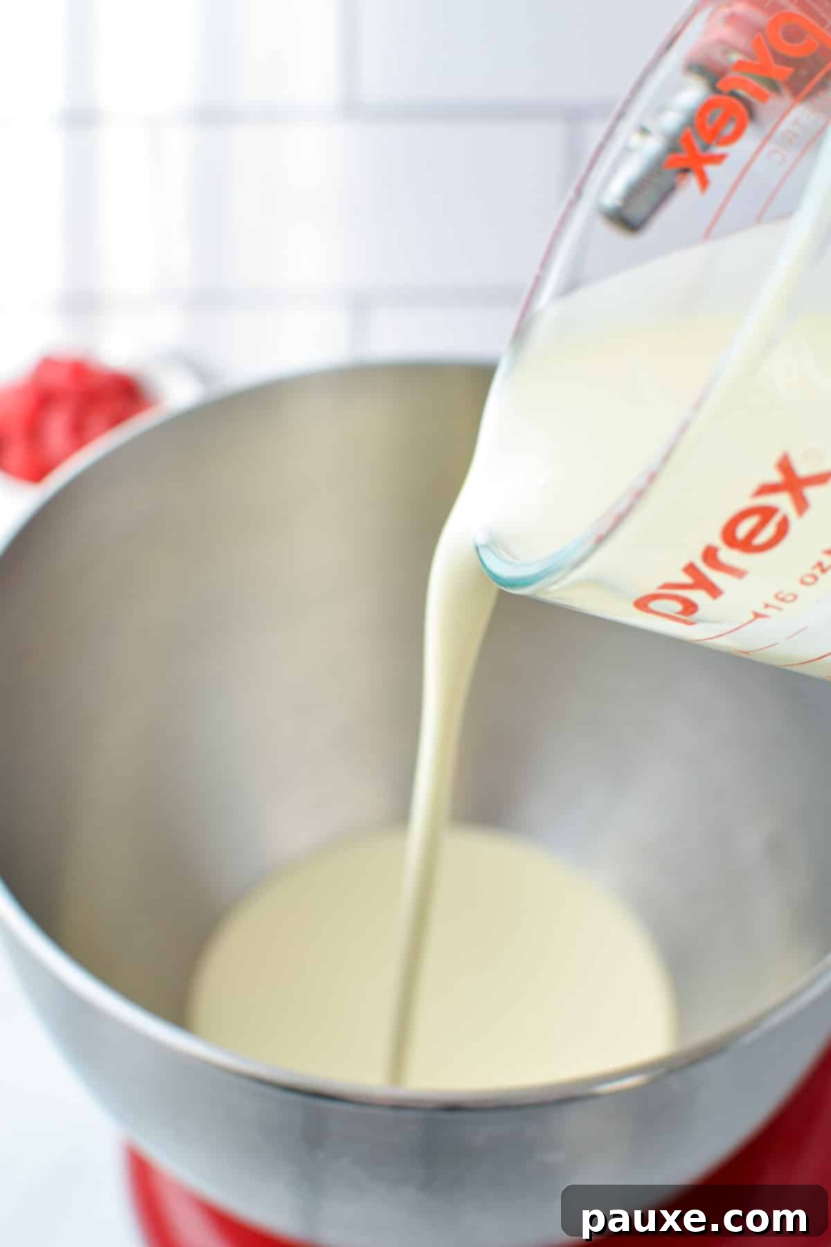 Pouring heavy cream into a bowl.