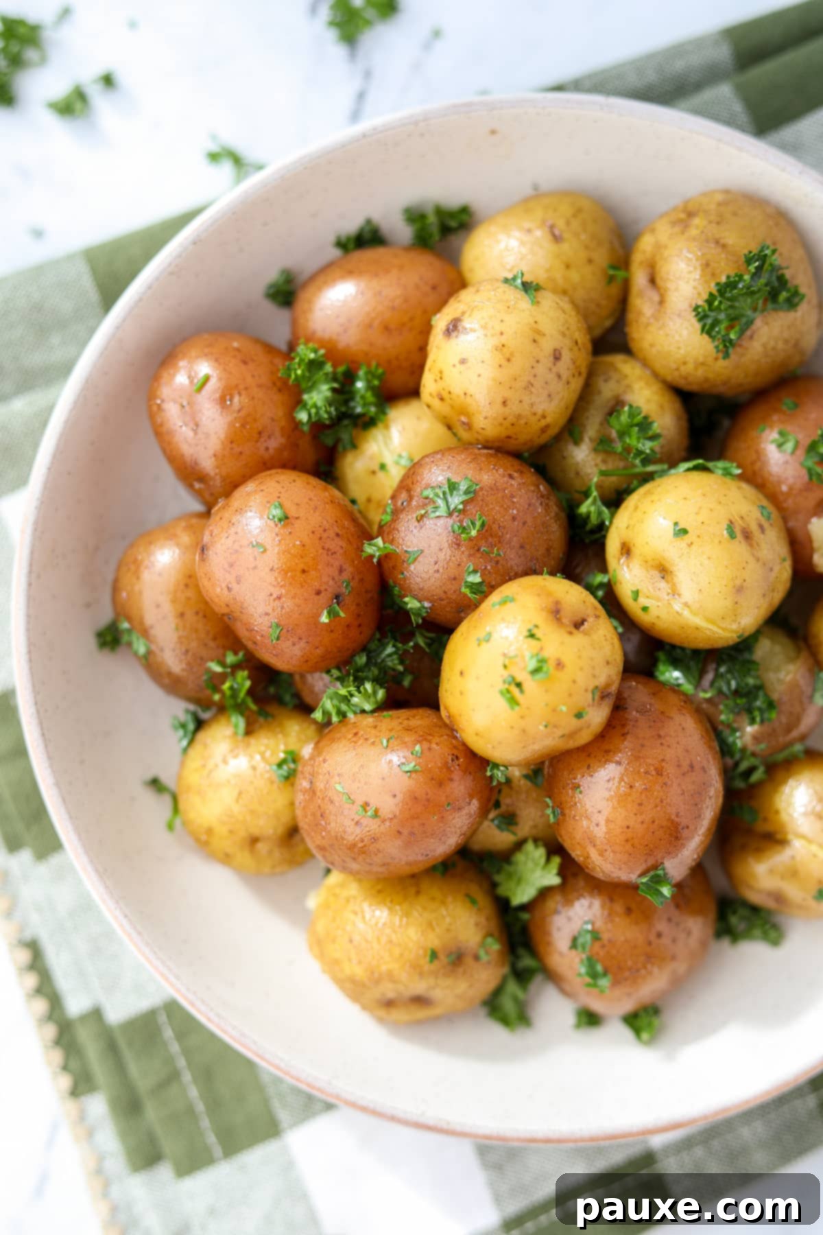 Perfect Instant Pot Baby Potatoes 7 A rustic bowl brimming with perfectly cooked, tender new potatoes, lightly seasoned and garnished with fresh green herbs.