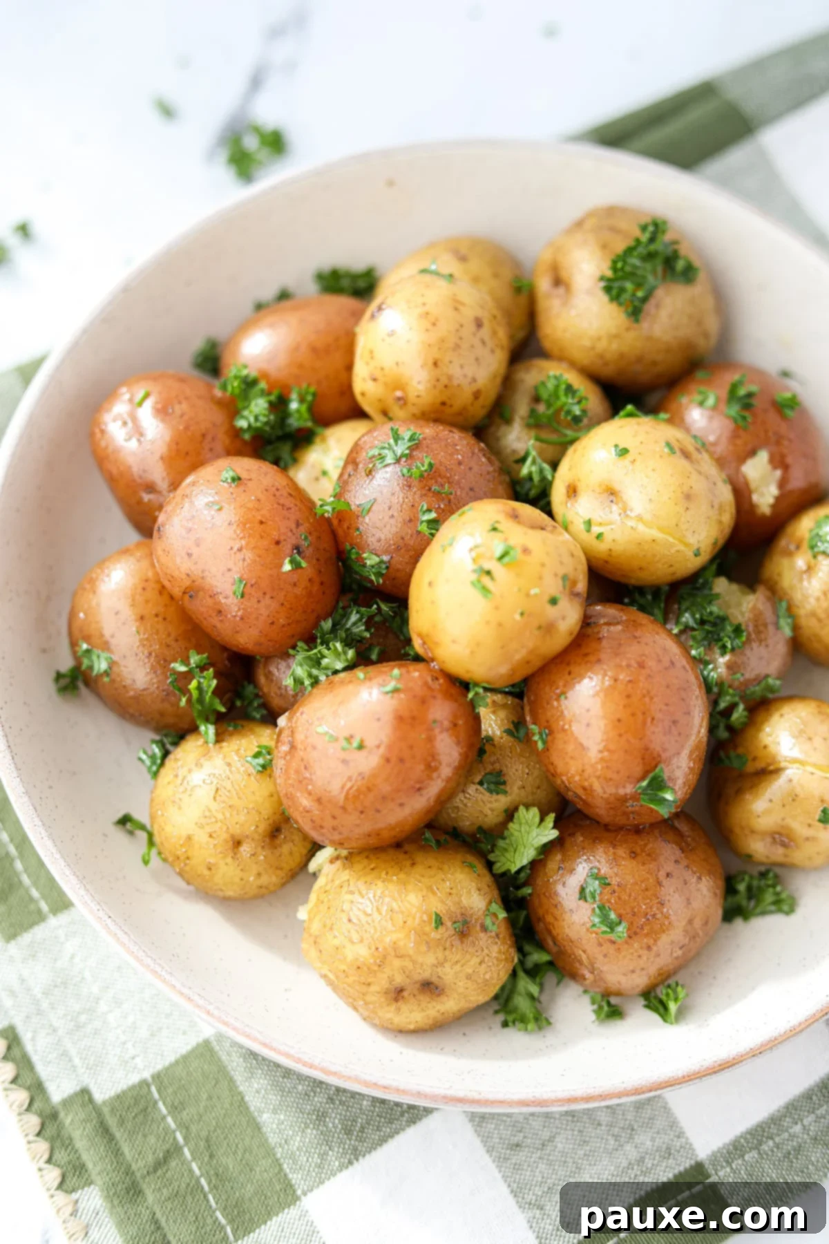 Perfect Instant Pot Baby Potatoes 8 A generously sized serving bowl overflowing with beautifully steamed and seasoned little potatoes, garnished with fresh herbs, ready for a family meal.