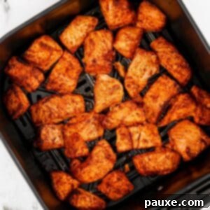Air-Fried Salmon Nuggets 12 An air fryer basket filled with salmon bites.
