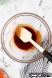 Air-Fried Salmon Nuggets 13 A large glass bowl with seasonings and oil being stirred together.