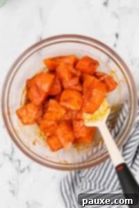 Air-Fried Salmon Nuggets 14 A glass bowl with salmon pieces that have been seasoned.