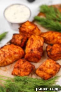 Air-Fried Salmon Nuggets 17 Salmon bites with a creamy dill sauce in the background.