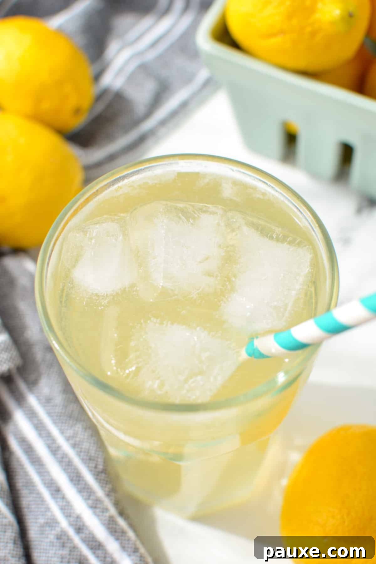 Solo Lemonade Delight 2 A glass of lemonade with a paper straw sticking out.