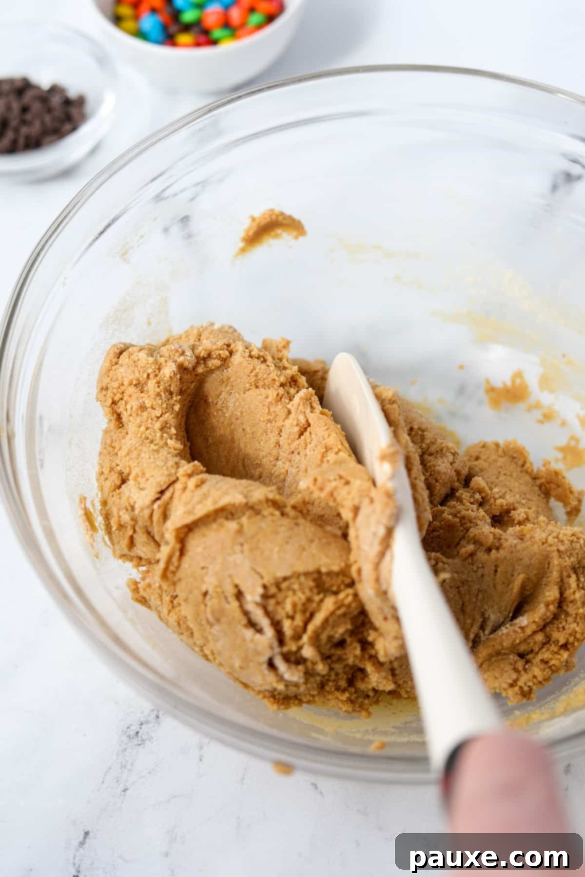 Protein-Packed Cookie Dough Bites 6 Mixing together a protein cookie dough in a bowl, demonstrating the proper consistency.