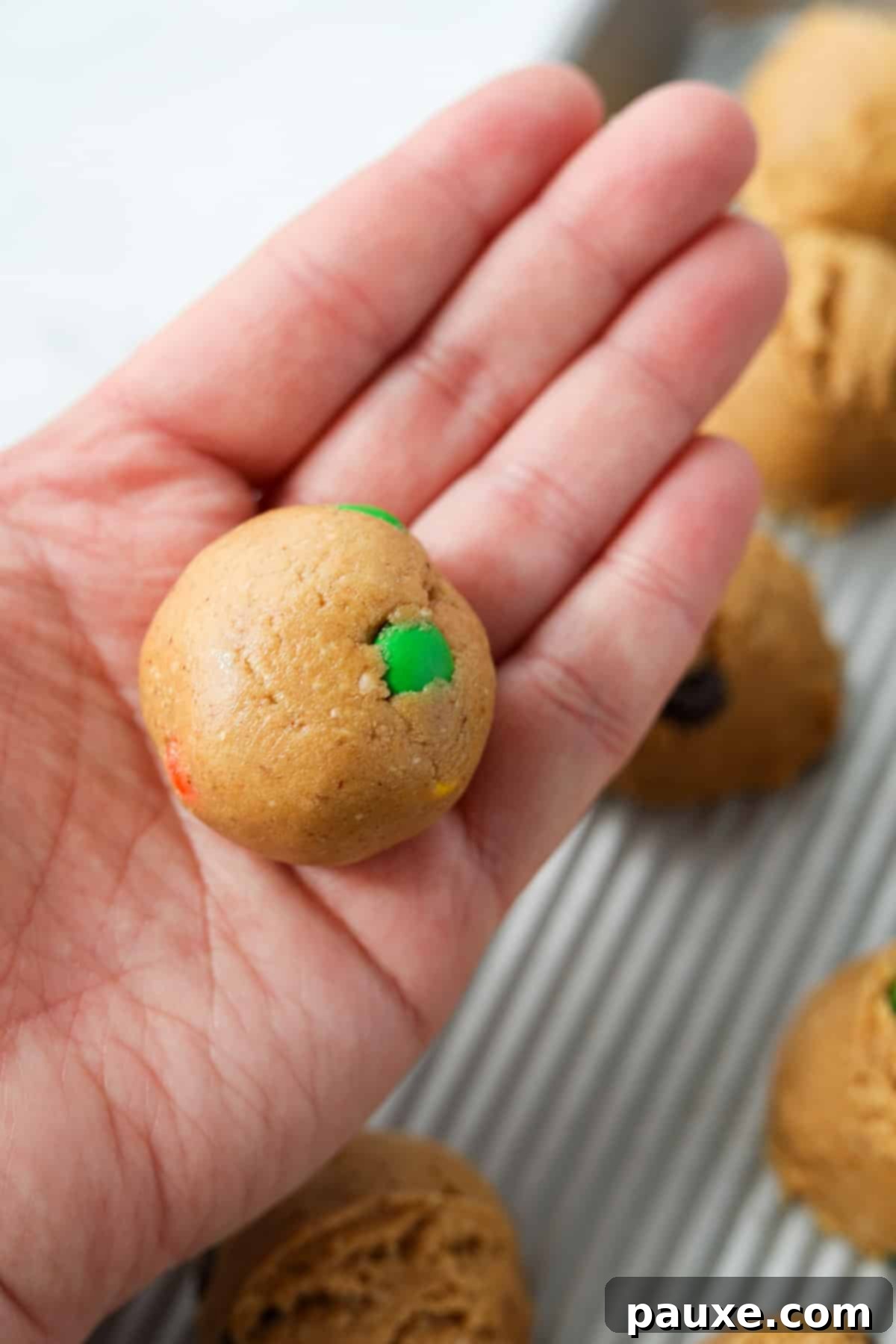 Protein-Packed Cookie Dough Bites 9 Rolling cookie dough into a smooth, round ball between palms.
