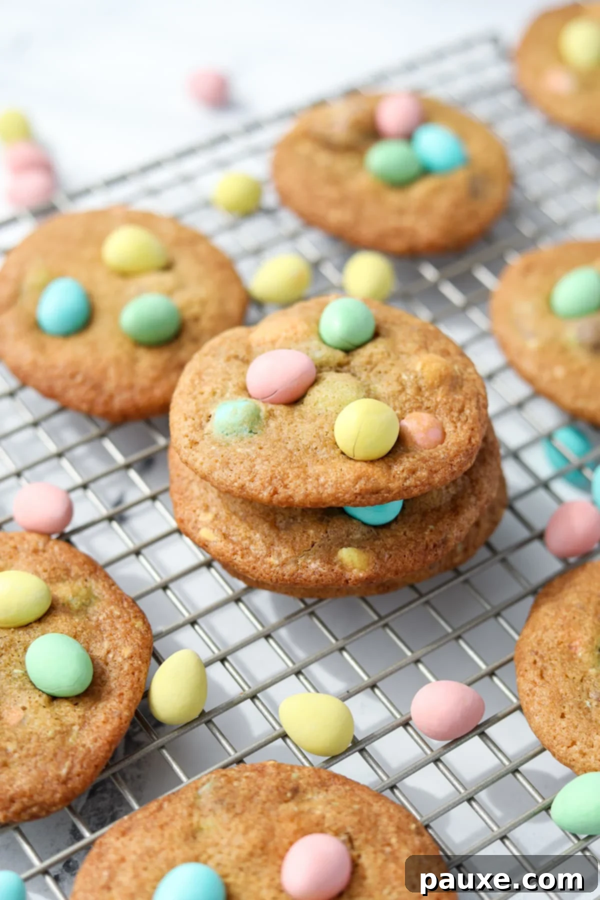 Speckled Spring Cookies 11 A close-up of delicious homemade cookies on a wire rack, beautifully topped with colorful Cadbury Mini Eggs.