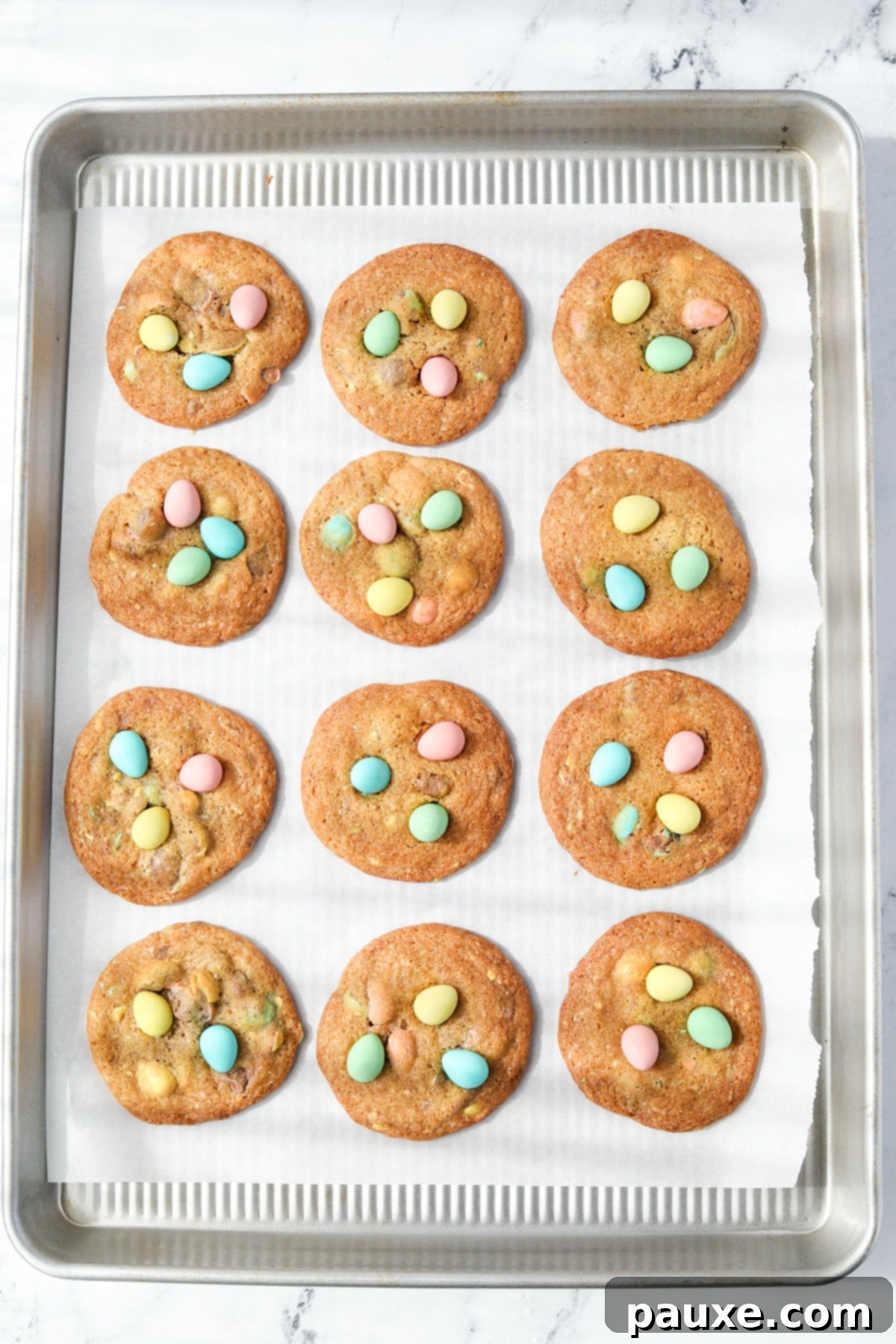 Speckled Spring Cookies 8 A baking sheet filled with freshly baked Cadbury Mini Egg cookies, glistening and warm.