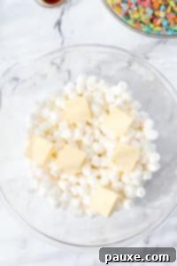 Colorful Pebbles Bars 12 A bowl with mini marshmallows and cubes of butter.