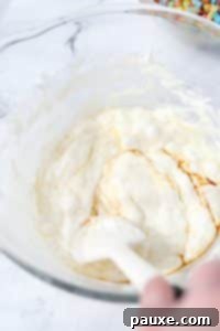 Colorful Pebbles Bars 13 Stirring melted marshmallows with butter and vanilla extract.