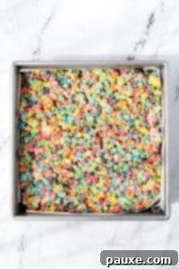 Colorful Pebbles Bars 15 A baking pan filled with Fruity Pebbles cereal treats.