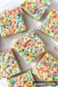 Colorful Pebbles Bars 16 Fruity pebbles treats on a white background.