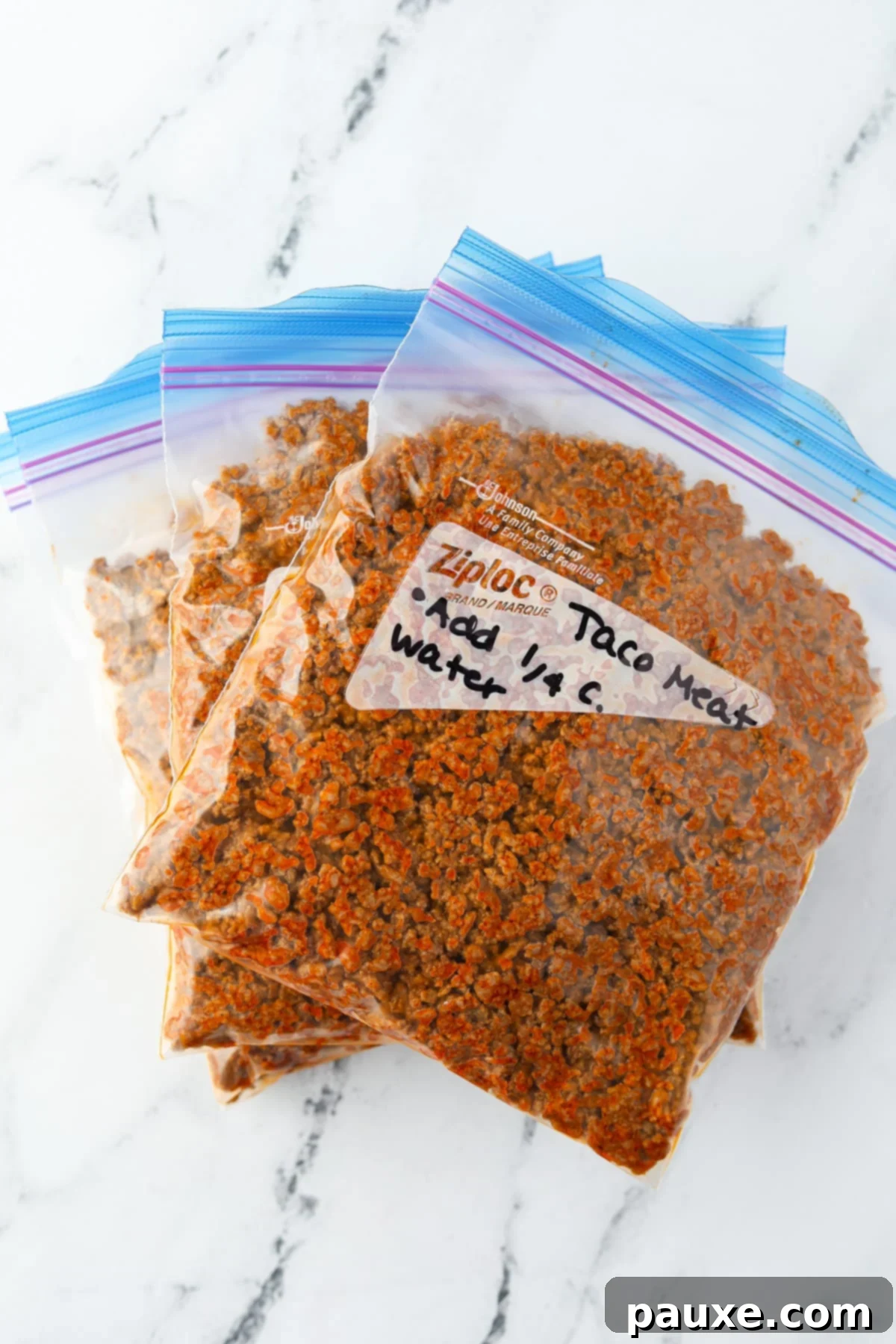 Three labeled freezer bags filled with perfectly seasoned ground beef taco meat, ready for the freezer.