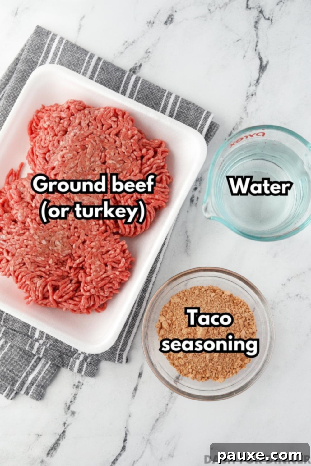 A package of fresh ground beef, a small bowl of water, and a bowl of taco seasoning on a light wooden surface.