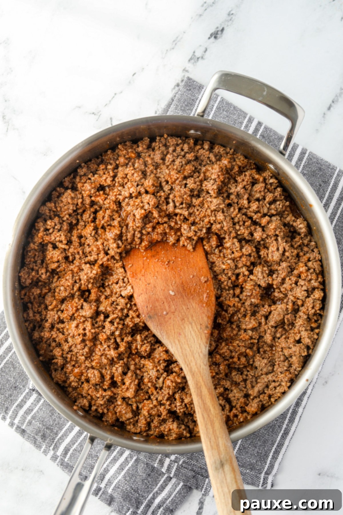 A skillet filled with perfectly seasoned ground beef taco meat, ready for cooling and freezing.