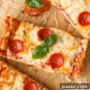Speedy French Bread Pizzas 13 A rectangular slice of pizza topped with pepperoni and basil.