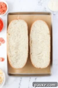 Speedy French Bread Pizzas 14 Two halves of a French Loaf on a baking pan.