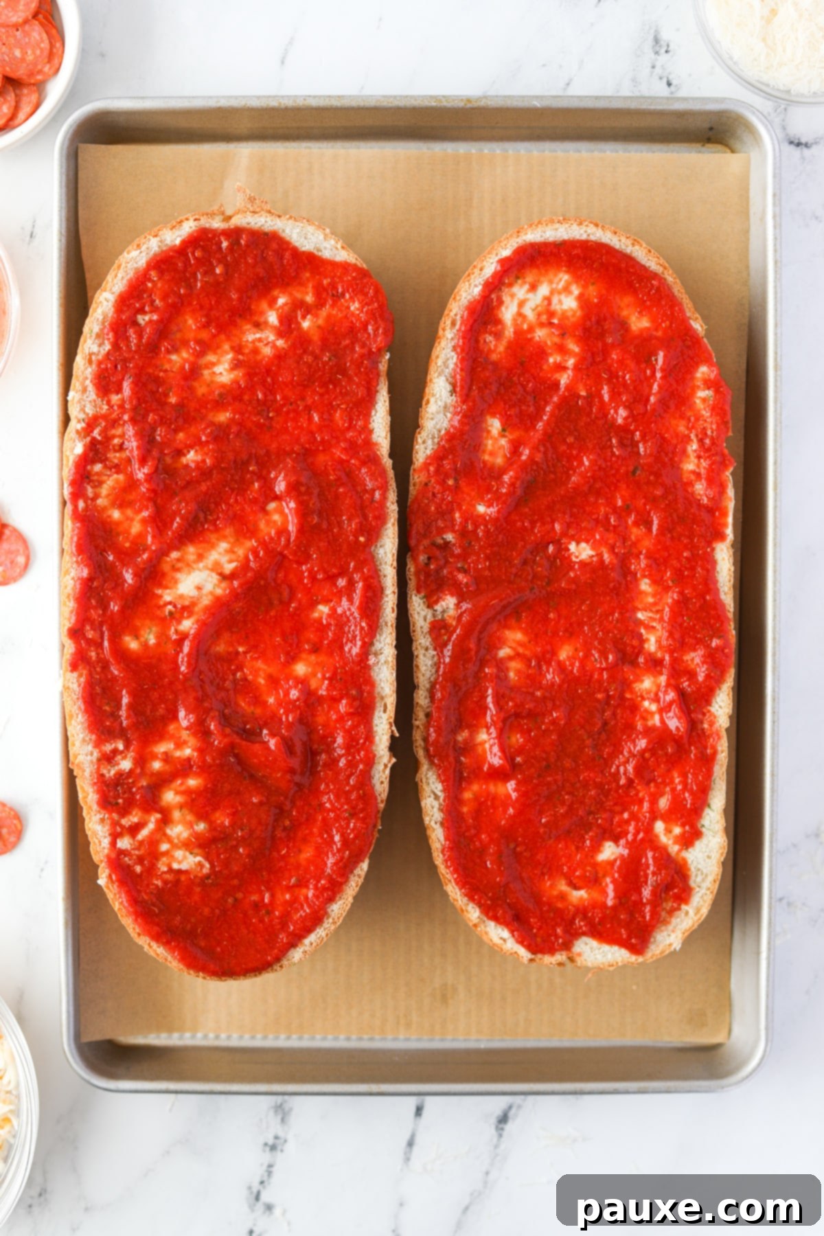 Speedy French Bread Pizzas 5 Spreading pizza sauce on French bread halves.