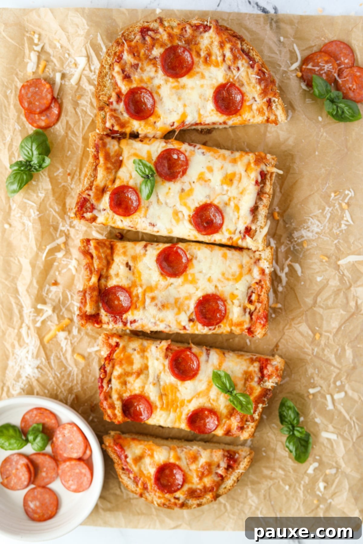 Speedy French Bread Pizzas 9 Pizza bread cut into slices on a baking sheet.