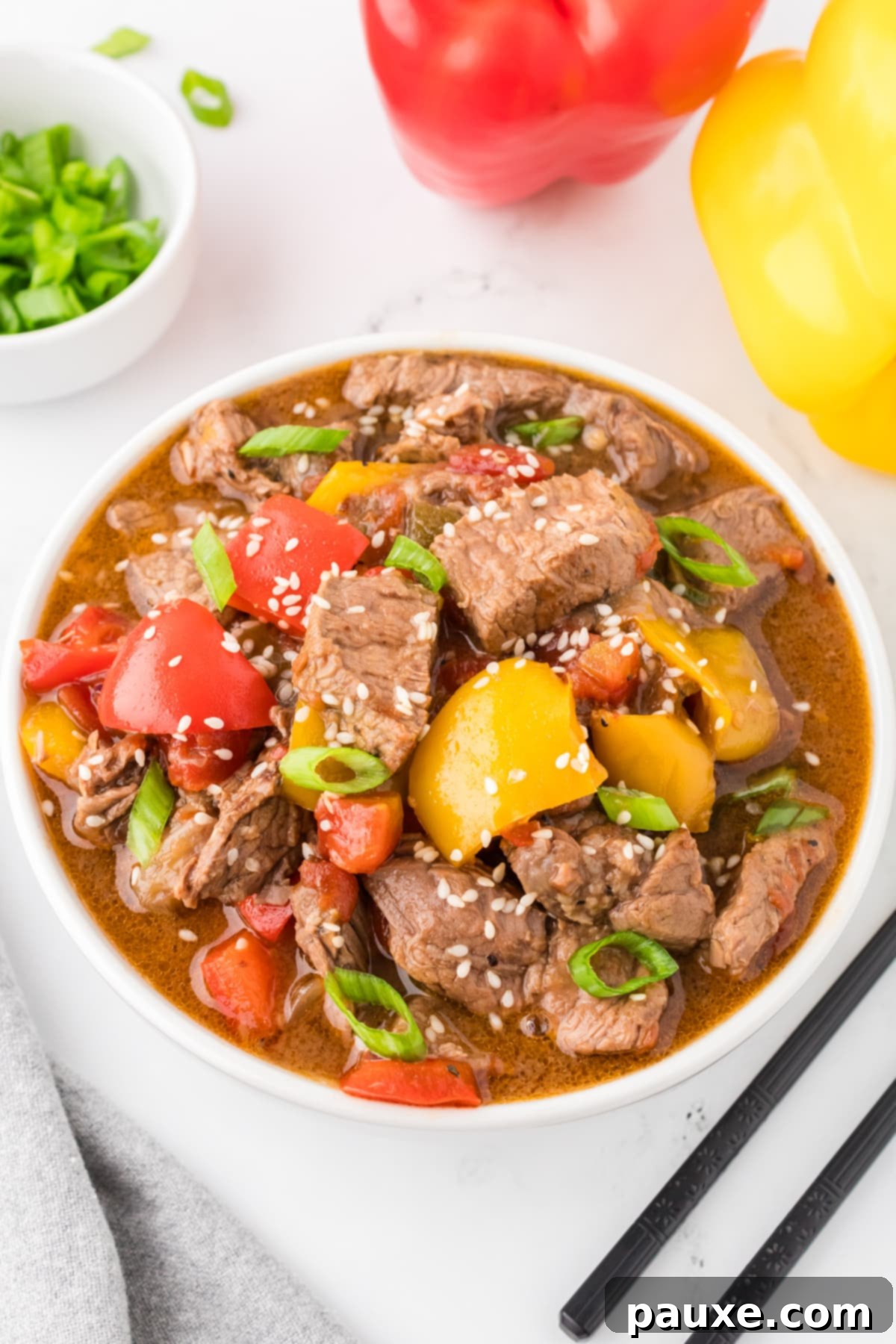 Easy Slow Cooker Pepper Steak 14 A bowl of pepper steak stir fry with vibrant bell peppers, showcasing the rich sauce.