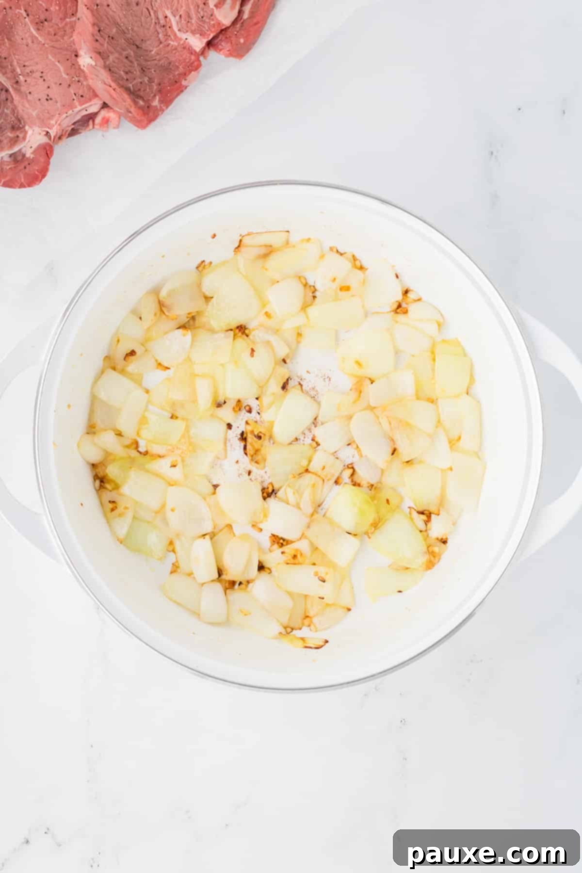 Easy Slow Cooker Pepper Steak 4 A Dutch Oven with sautéed onions and garlic, lightly browned and fragrant.