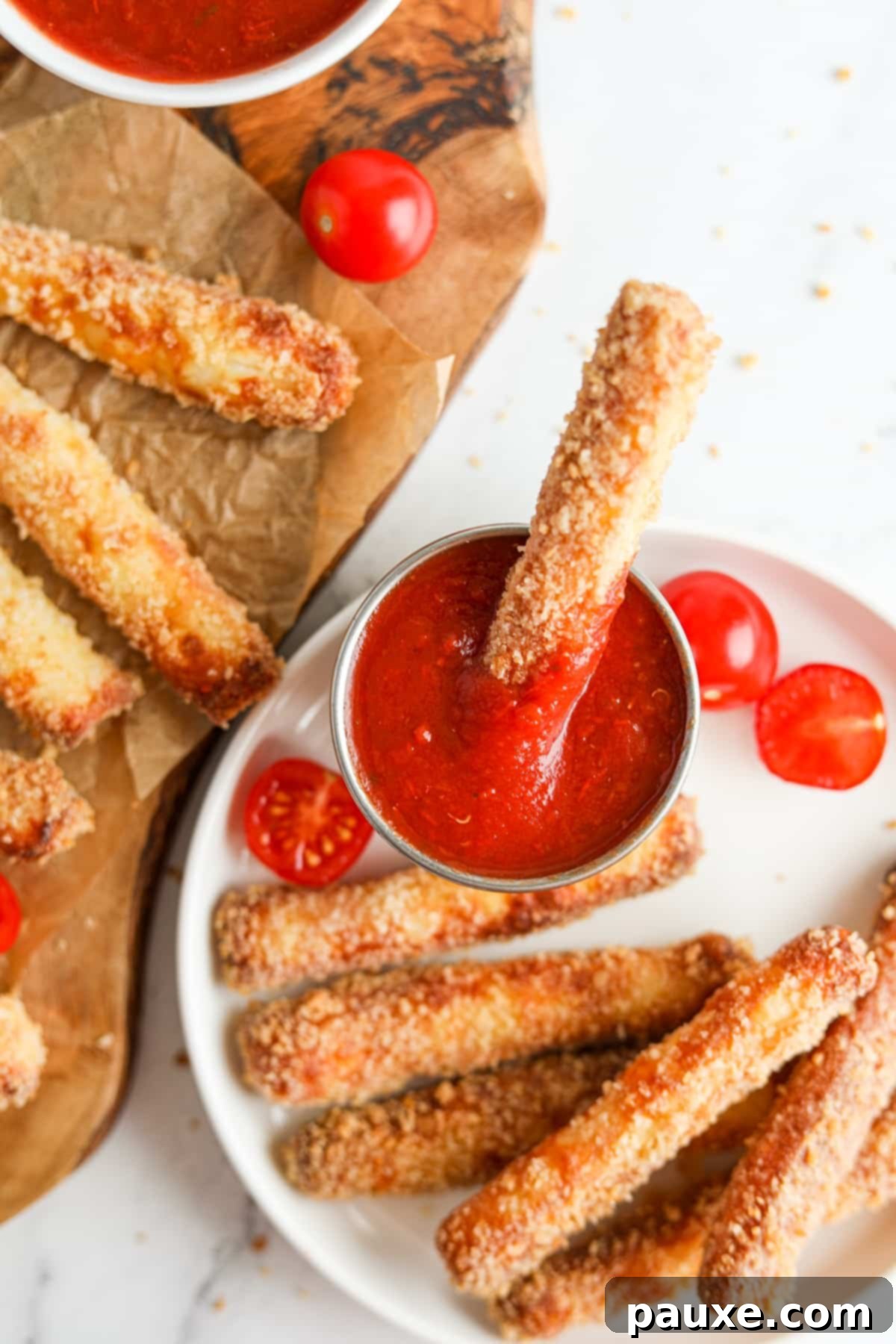 Crispy Air Fryer Halloumi Fries 12 A close-up shot of a golden, air-fried halloumi fry being dipped into a small white bowl of rich pizza sauce.