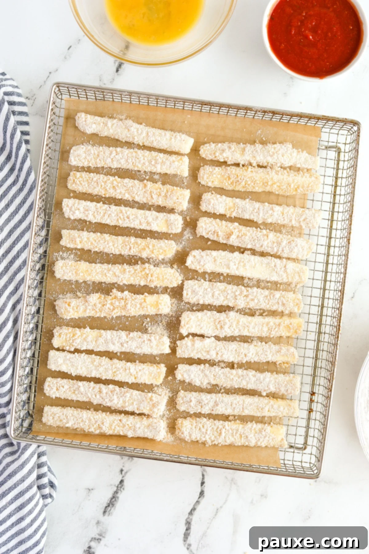 Crispy Air Fryer Halloumi Fries 8 Breaded halloumi sticks neatly arranged in a single layer on an air fryer tray, ready for cooking.