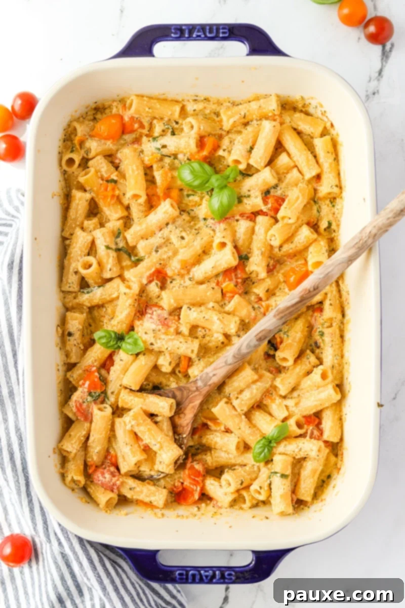Creamy Boursin Pasta Bake 10 A baking dish filled with creamy Boursin pasta, beautifully garnished with fresh basil leaves, ready to be enjoyed.