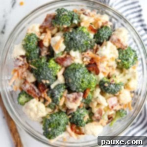 Creamy Amish Broccoli Salad 13 A bowl of broccoli salad garnished with cheese and bacon.