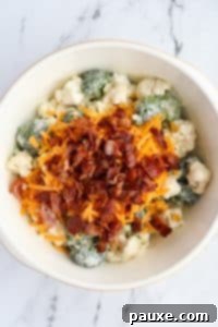 Creamy Amish Broccoli Salad 16 A bowl of broccoli salad with cheese and bacon on top.