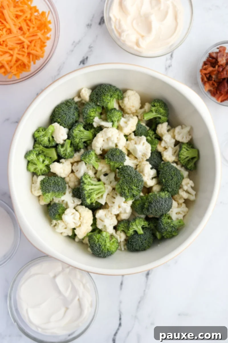 Creamy Amish Broccoli Salad 4 A very large mixing bowl filled with freshly cut, bite-sized broccoli and cauliflower florets, ready for the dressing.