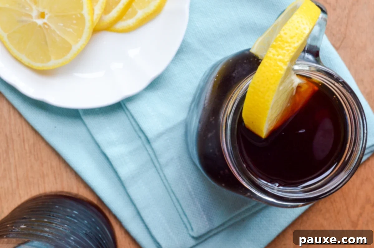 Crystal Clear Instant Pot Iced Tea 8 A glass of Instant Pot Iced tea garnished with a lemon slice, ready to drink.