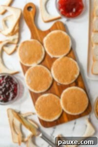 DIY Crustless Sandwich Pockets 15 Spreading peanut butter on rounds of bread.