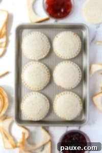 DIY Crustless Sandwich Pockets 18 A baking sheet with round pressed sandwiches on it.