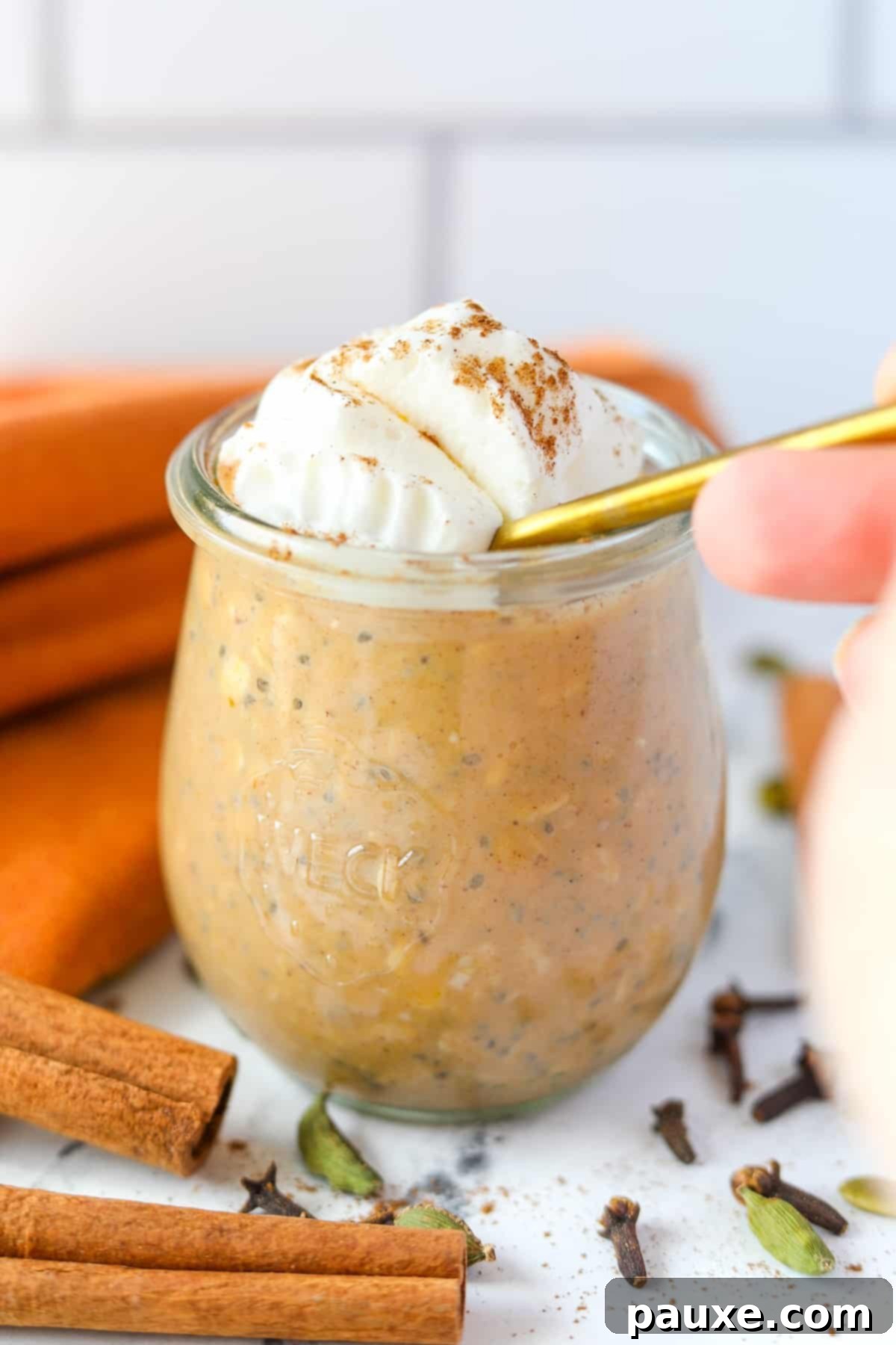 Pumpkin Spice Overnight Oats 12 A spoon diving into a jar of overnight oats.