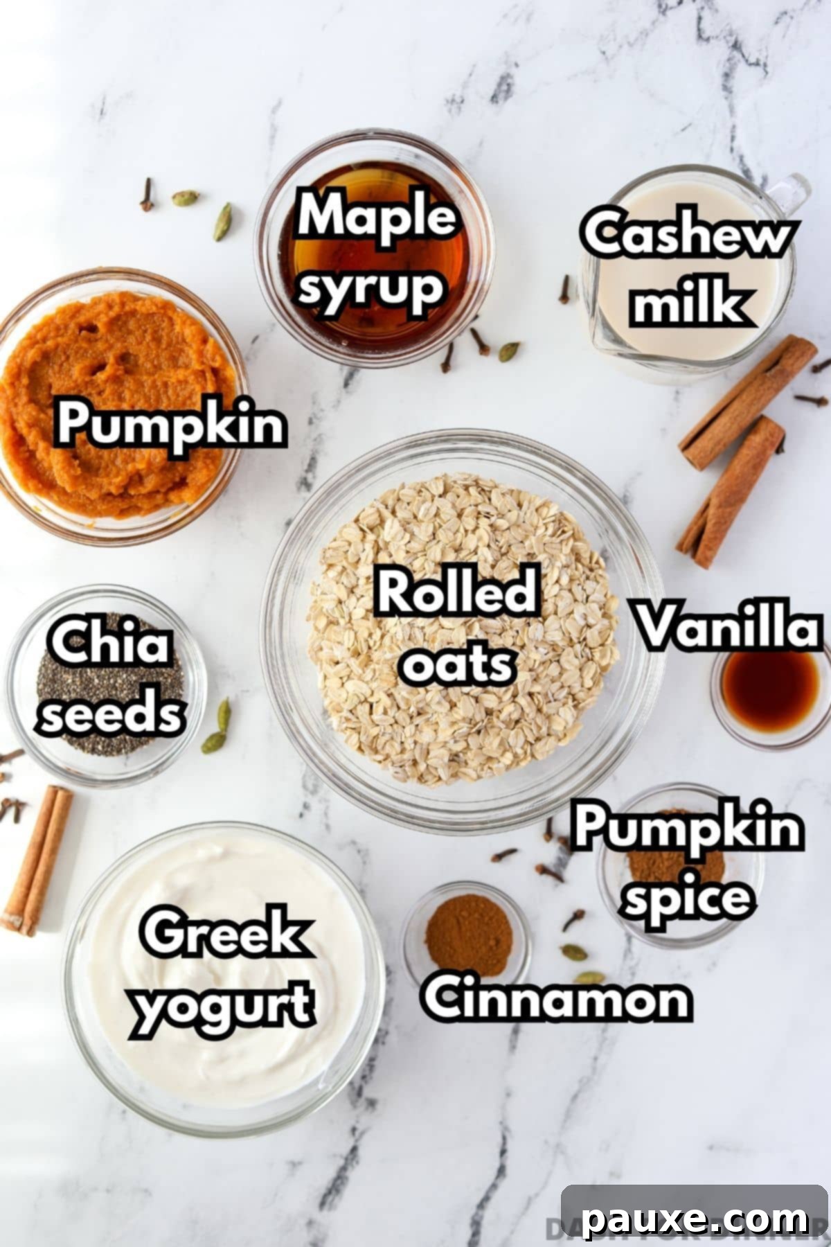 Pumpkin Spice Overnight Oats 3 The ingredients needed to make overnight oats: rolled oats, yogurt, chia, pumpkin, maple syrup, etc. laid out on a white surface.