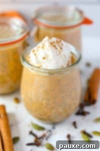 Pumpkin Spice Overnight Oats 20 A jar of overnight oats, garnished with whipped cream and a pinch of pumpkin spice on top.