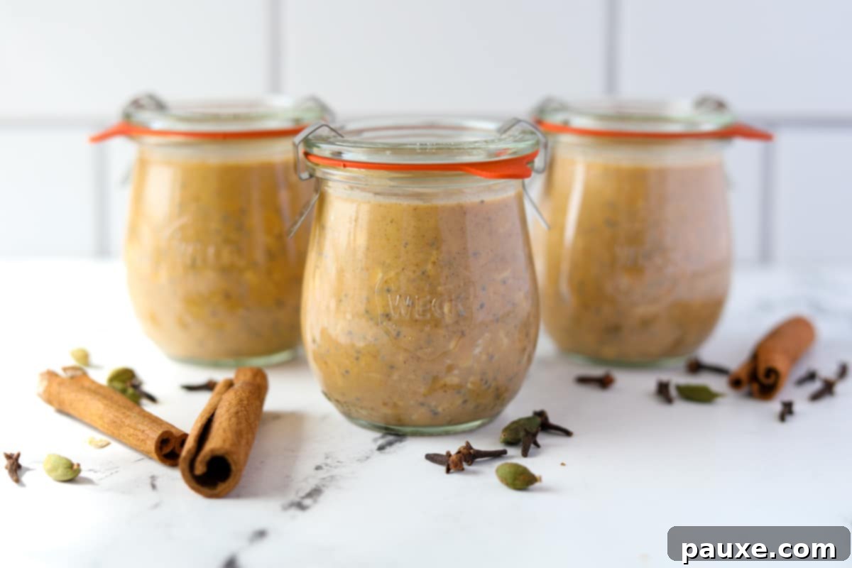 Pumpkin Spice Overnight Oats 10 Three jars filled with pumpkin overnight oatmeal, resting on a countertop.