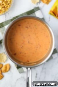 Zesty Fiesta Dip 17 A saucepan with Rotel dip melted inside.