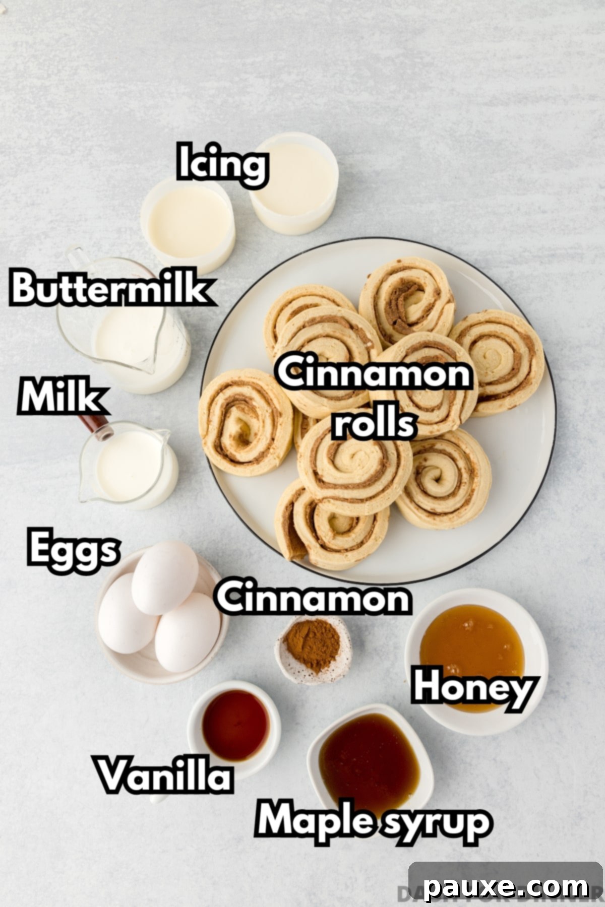 Gooey Cinnamon Bliss Bake 3 All the ingredients laid out for making cinnamon roll casserole, including canned rolls, eggs, milk, syrup, and honey.
