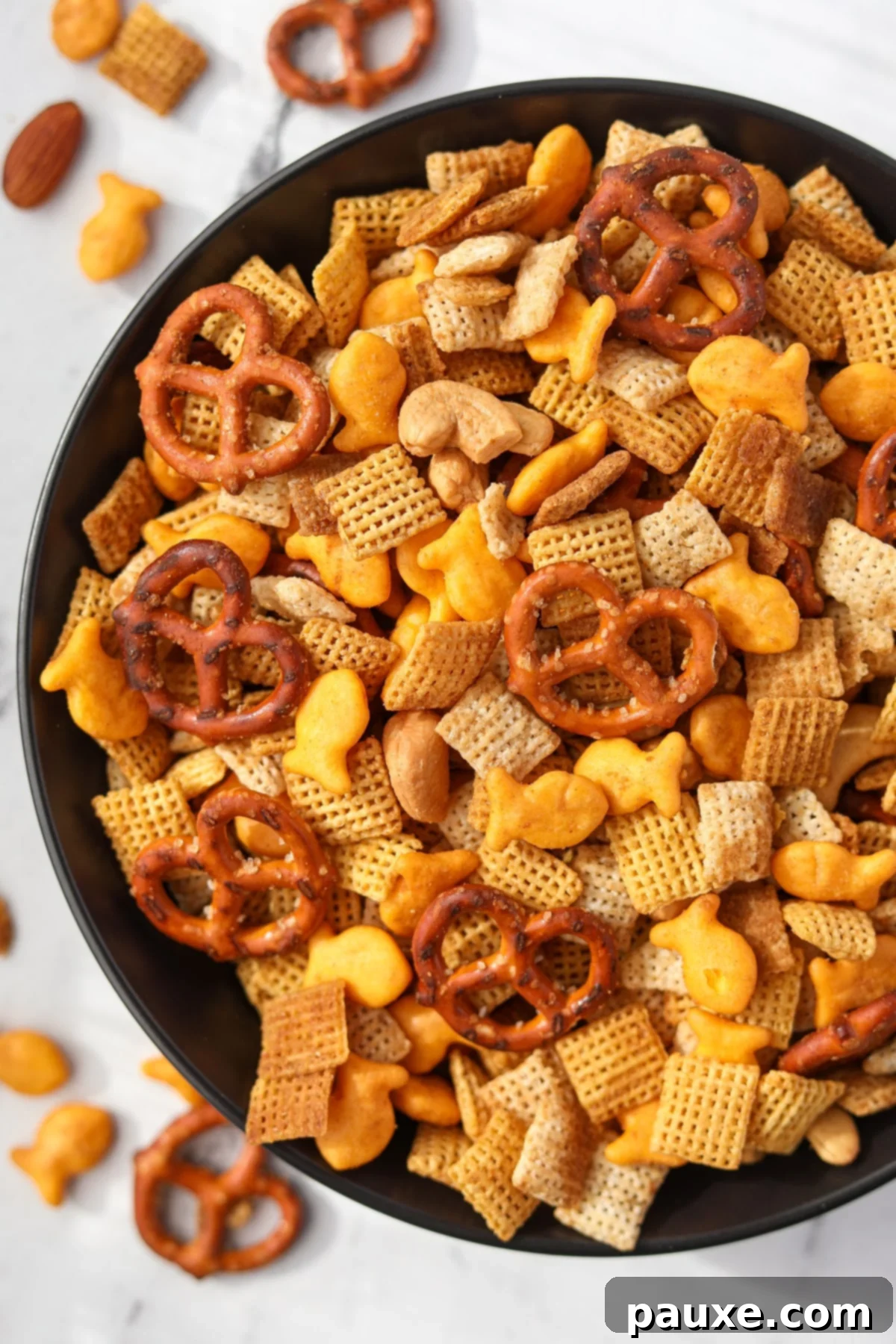 Savory Goldfish Crunch Mix 2 A bowl of homemade snack mix featuring pretzels, crackers, and chex cereal.