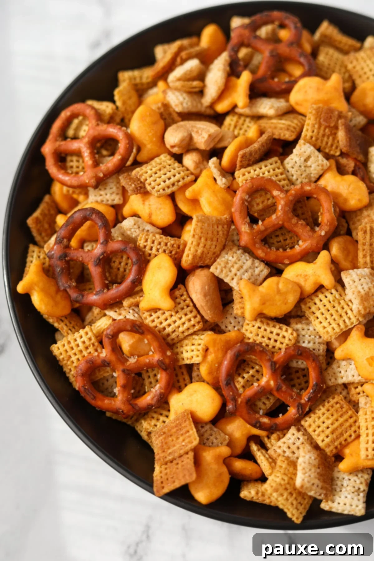 Savory Goldfish Crunch Mix 14 A black bowl with homemade chex mix in it.