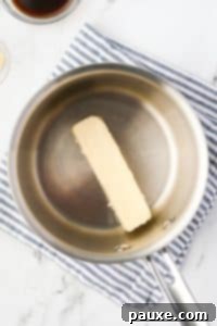 Savory Goldfish Crunch Mix 17 A saucepan with a stick of butter in it.