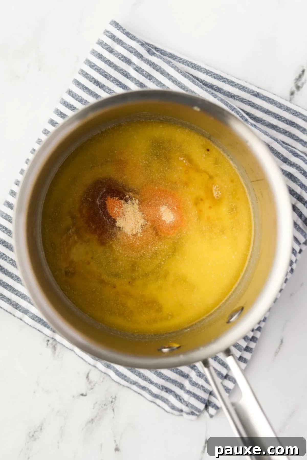 Savory Goldfish Crunch Mix 6 A pot filled with melted butter and seasonings.