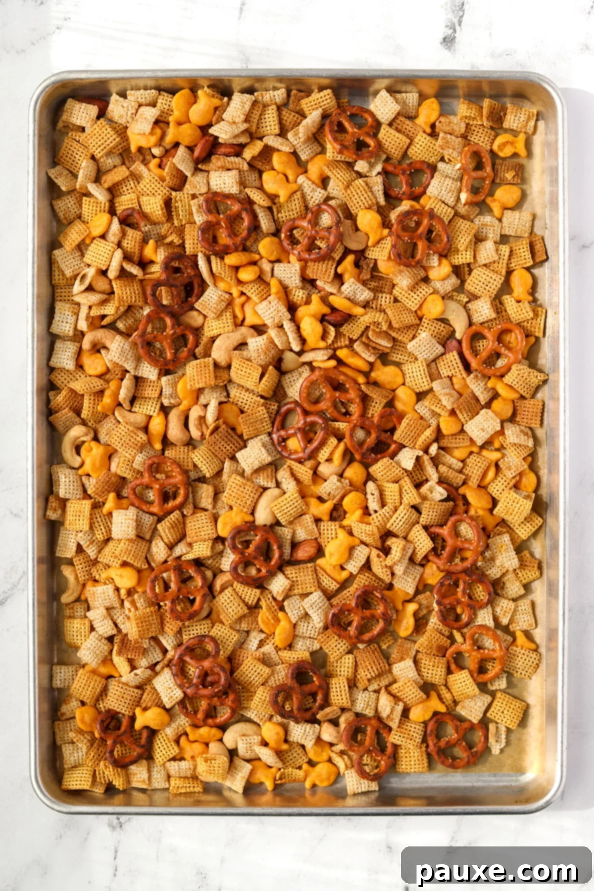 Savory Goldfish Crunch Mix 9 A baking pan with homemade snack mix on it.