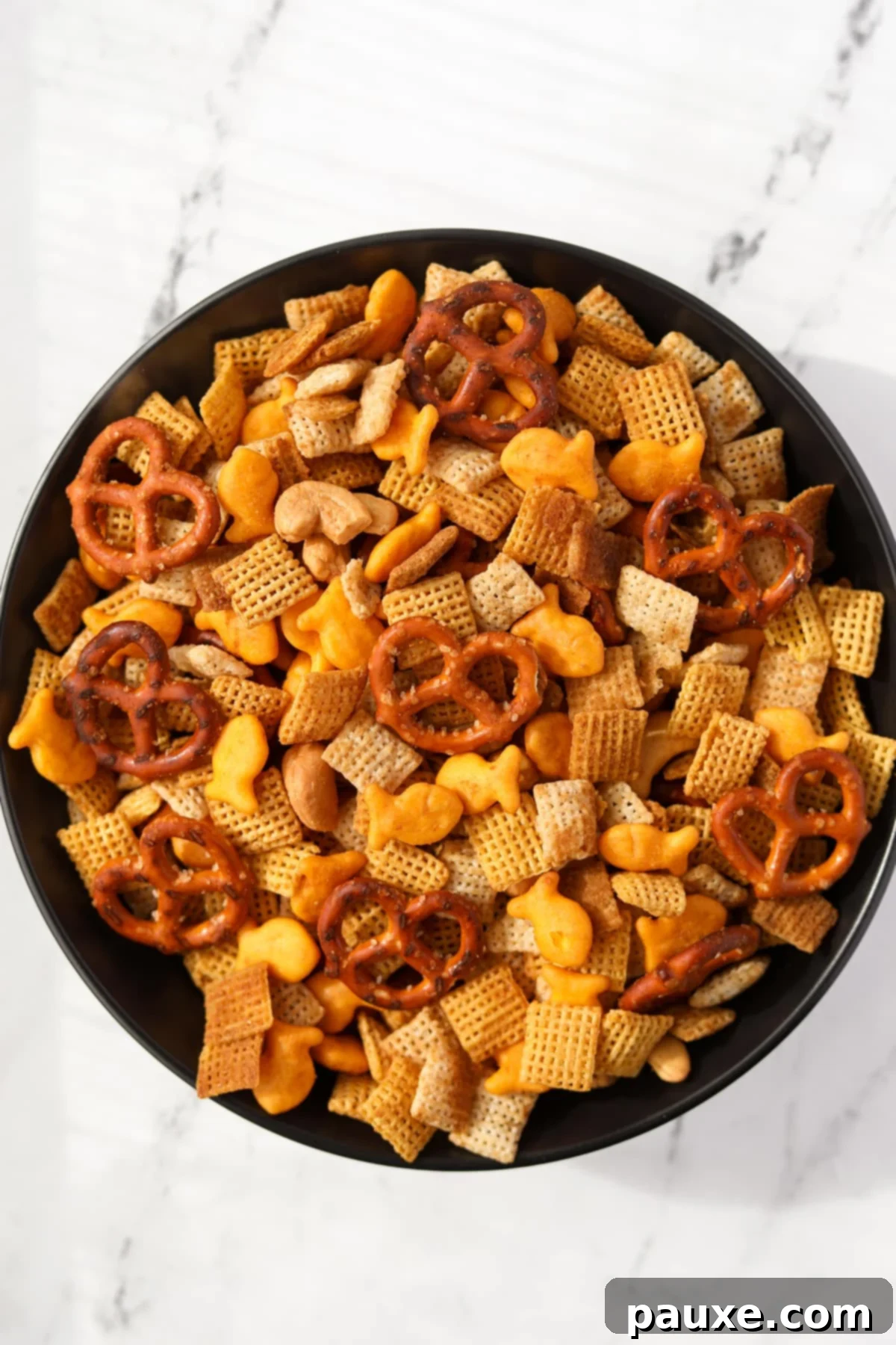 Savory Goldfish Crunch Mix 10 A bowl of homemade snack mix with pretzels, crackers, cereal, and nuts.