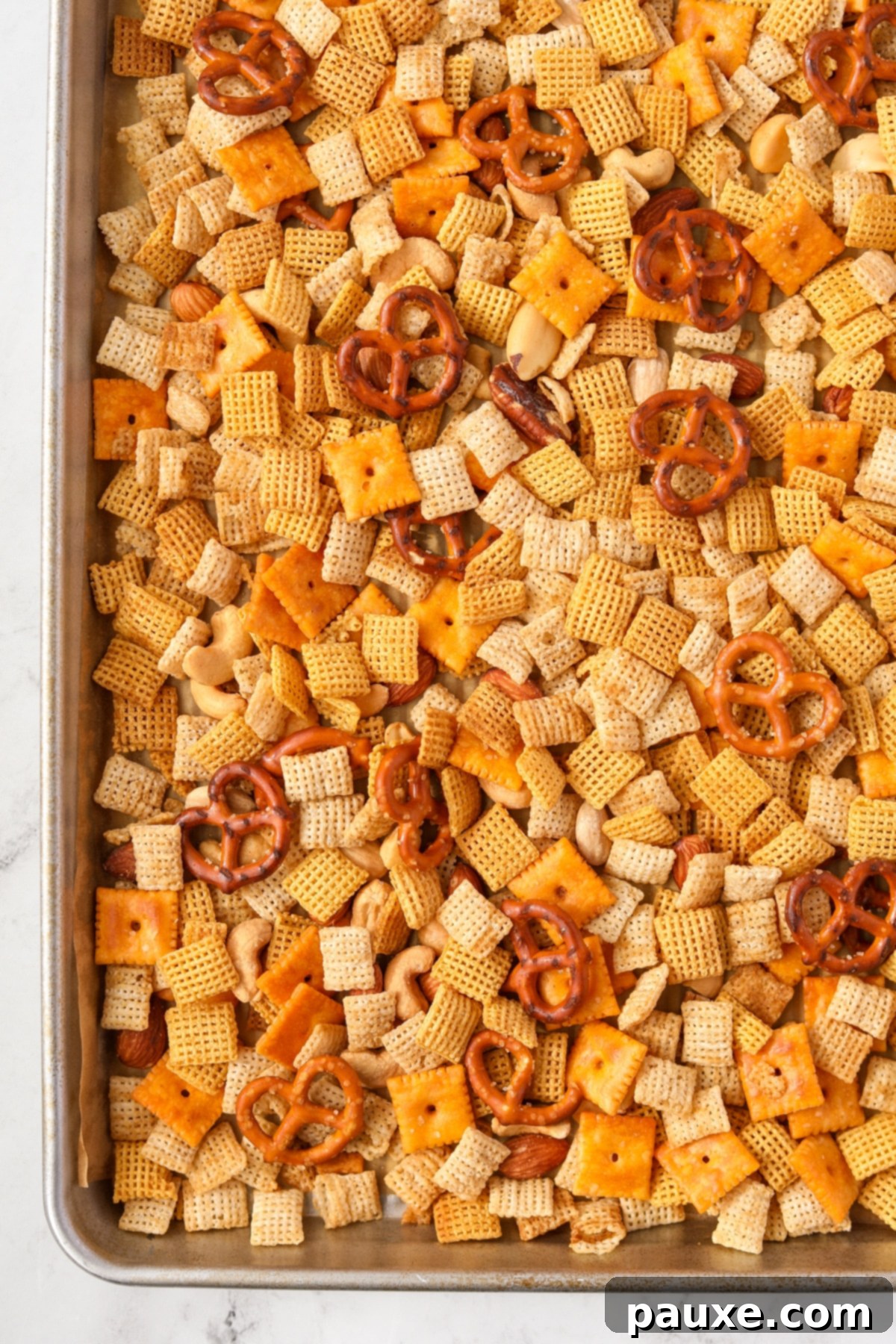 Savory Snack Medley 12 A baking sheet filled with a generous amount of homemade Chex Mix, golden and crispy from the oven.