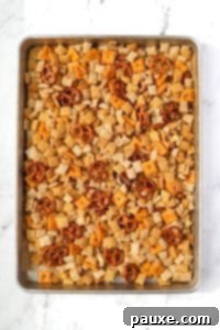 Savory Snack Medley 19 A baking sheet filled with snack mix, showing pretzels, cereal, and crackers spread out.