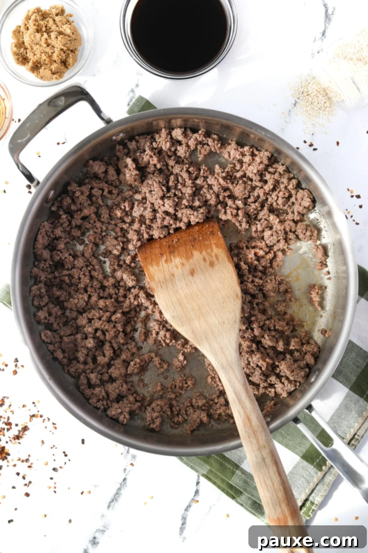 Authentic Korean Marinated Beef 4 Browning lean ground beef in a large skillet over medium heat, breaking it apart with a spatula.